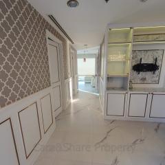 Modern kitchen with marble flooring and patterned wall design