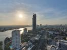 Panoramic view from a property overlooking a river and cityscape during sunset