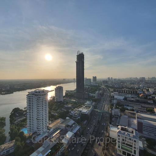 Panoramic view from a property overlooking a river and cityscape during sunset
