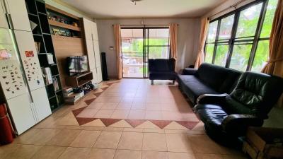 Spacious living room with natural light and tiled flooring