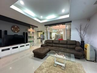 Modern spacious living room with ample lighting and contemporary furniture