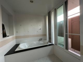 Spacious bathroom with large bathtub and window