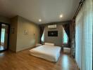 Spacious bedroom with hardwood floors and modern air conditioning
