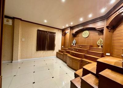 Spacious living room with wooden paneling and modern lighting