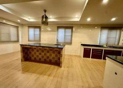 Spacious modern kitchen with wooden flooring and LED lighting