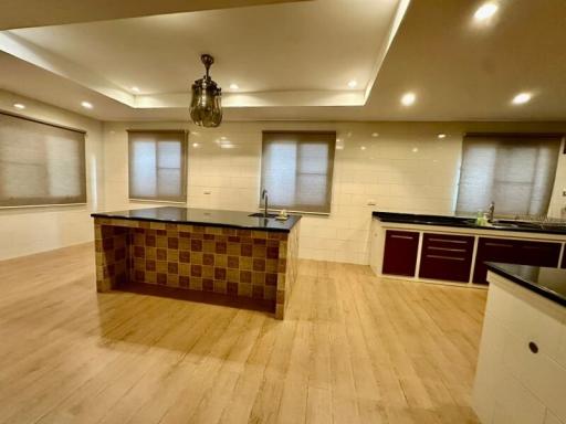 Spacious modern kitchen with wooden flooring and LED lighting