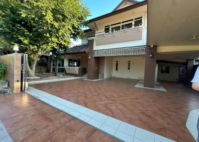 Spacious outdoor area of a residential home with tiled flooring and a view of the building façade