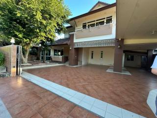 Spacious outdoor area of a residential home with tiled flooring and a view of the building façade