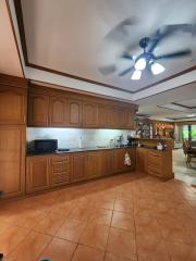 Spacious kitchen with wooden cabinets and tiled floor