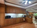 Spacious kitchen with wooden cabinets and tiled floor