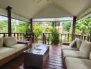 Spacious covered patio with comfortable seating and tropical views