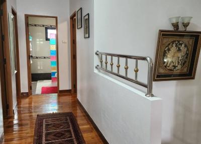 Elegant hallway interior with wooden floors and decorative wall art