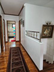 Elegant hallway interior with wooden floors and decorative wall art
