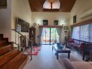 Spacious living room with high ceiling and natural light