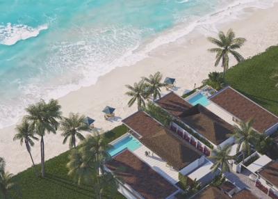 Aerial view of beachfront property with pool and palm trees