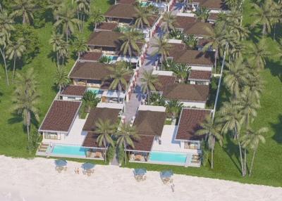 Aerial view of a tropical beachfront resort with palm trees