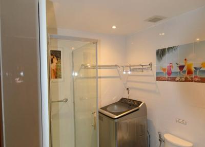 Compact modern bathroom with shower and appliances