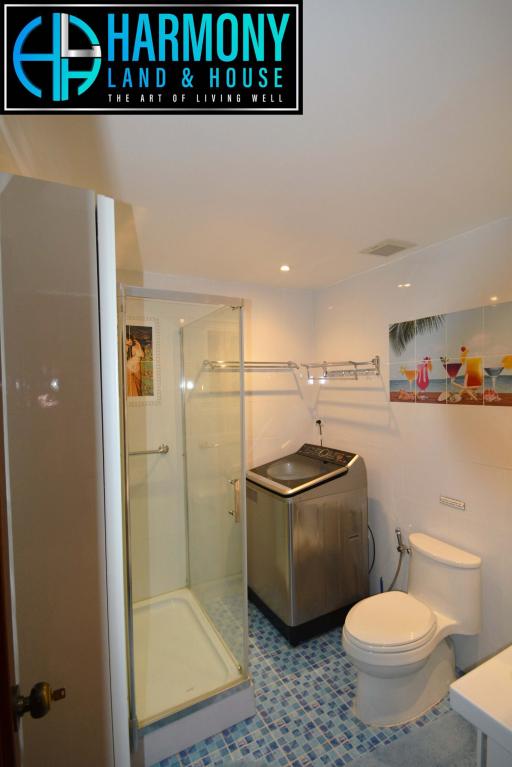 Compact modern bathroom with shower and appliances