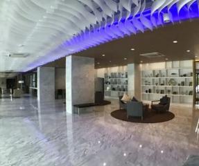Modern lobby interior with artistic ceiling design and marble floors