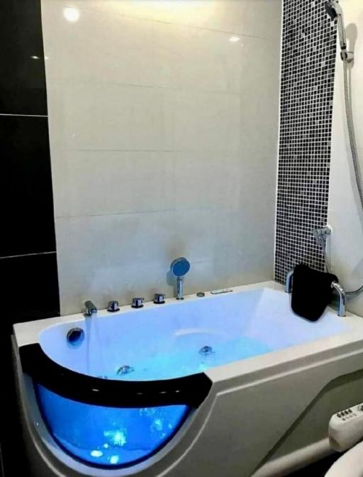 Modern bathroom with a jacuzzi tub and LED lighting