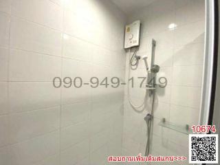 Compact bathroom with white tiles and electric shower