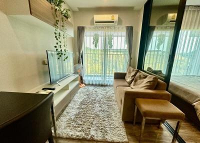 Cozy and well-lit living room with modern furniture and balcony access