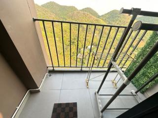 A balcony with scenic mountain views and drying rack