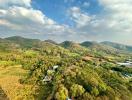 Aerial view of lush greenery and rolling hills surrounding a property