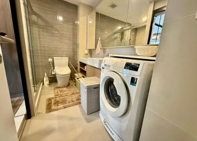 Modern bathroom with laundry appliances