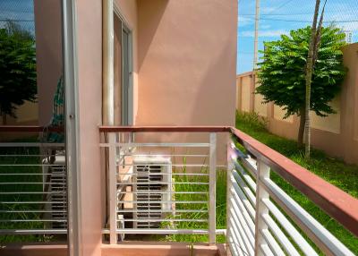 Spacious balcony with terracotta tiles and white railings