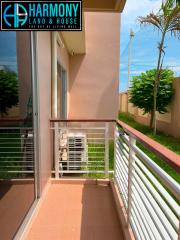 Spacious balcony with terracotta tiles and white railings