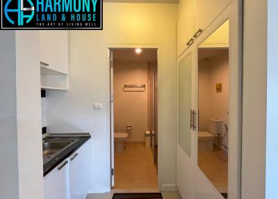 Interior view showing corridor with kitchenette and open bathroom door