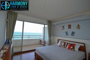 Spacious bedroom with ocean view and balcony access