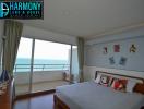 Spacious bedroom with ocean view and balcony access