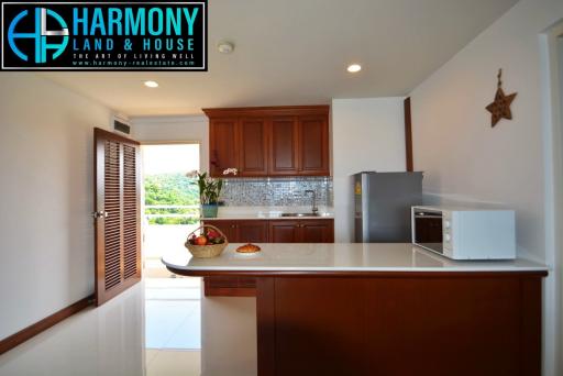 Modern kitchen with wooden cabinets and stainless steel appliances