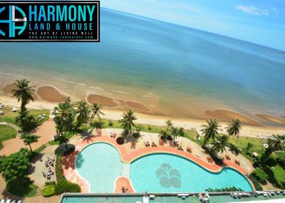 Aerial view of a residential complex with a swimming pool by the beach