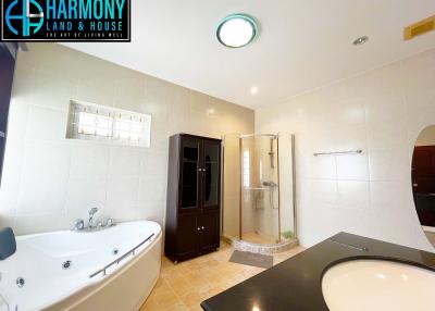 Spacious bathroom with modern fixtures and separate shower and bathtub