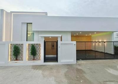 Modern single-story residential home facade during twilight