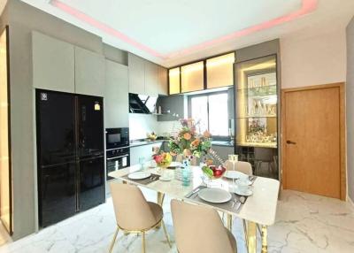 Modern kitchen with dining area and integrated appliances