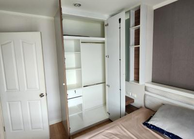 Cozy bedroom interior with built-in wardrobe and natural light