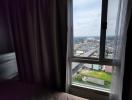 Cozy bedroom with a city view through the window