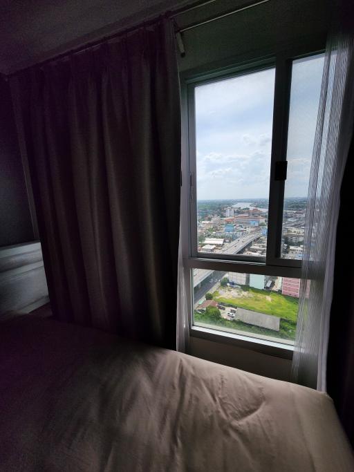 Cozy bedroom with a city view through the window