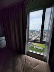 Bedroom with a view of the cityscape through a large window