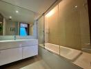 Modern bathroom with large mirror and bathtub