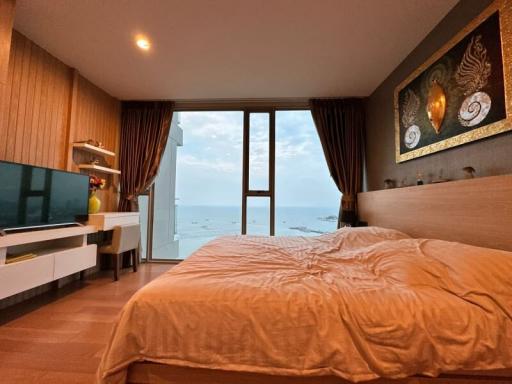 Bedroom with a sea view, king-size bed, and modern furniture