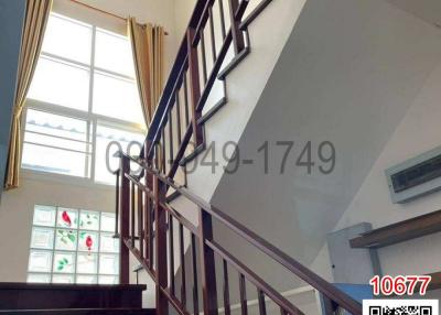 Elegant staircase with wooden banister in a well-lit interior space