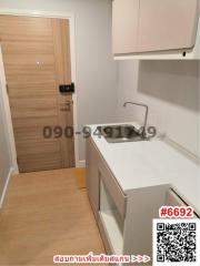 Compact modern kitchen with wooden flooring and white cabinetry