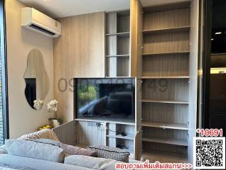 Modern living room with mounted television and shelving units