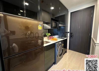 Modern kitchen with stainless steel appliances and black cabinetry