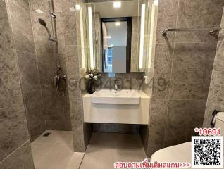 Modern bathroom with walk-in shower and illuminated mirror